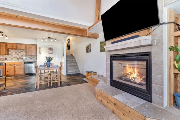 a living room with furniture a flat screen tv and a fireplace