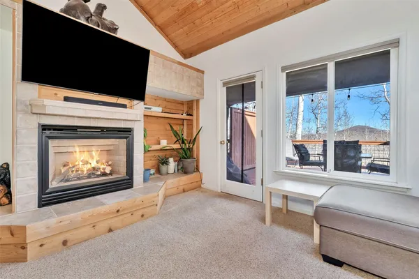 a living room with furniture fireplace and flat screen tv