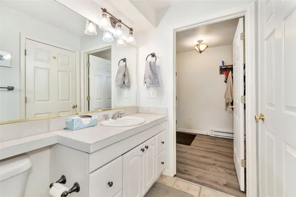 a bathroom with a double vanity sink mirror and shower