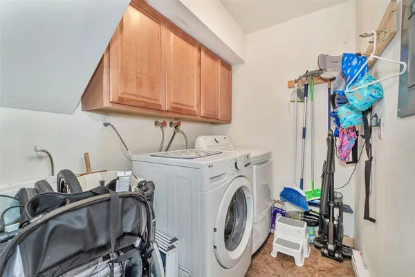 a utility room with dryer washer and a sink