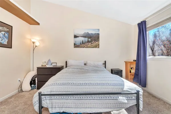 a bedroom with bed and a window