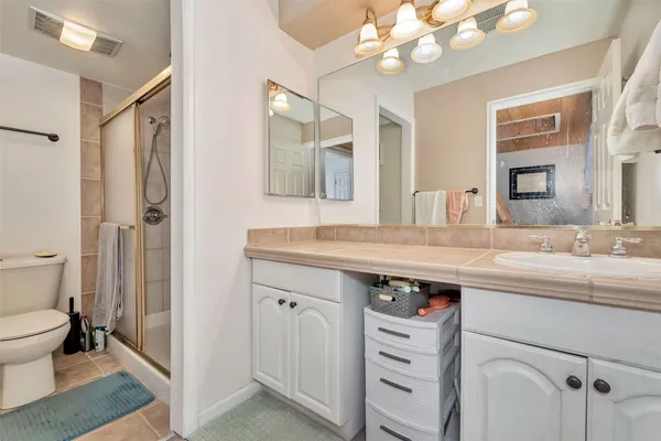 a bathroom with a sink a toilet and a mirror