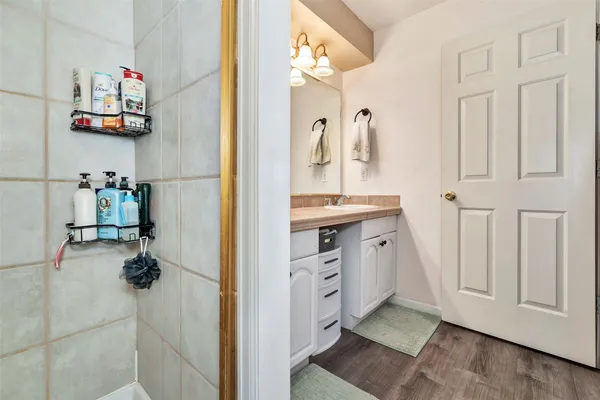 a view of bedroom with baby crib and furniture