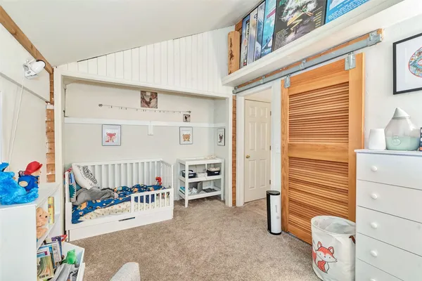 a living room with furniture and a book shelf