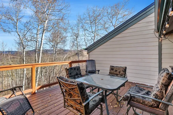 a view of a wooden chairs on the deck
