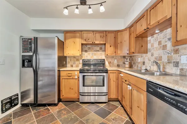 a kitchen with stainless steel appliances cabinets and a counter top