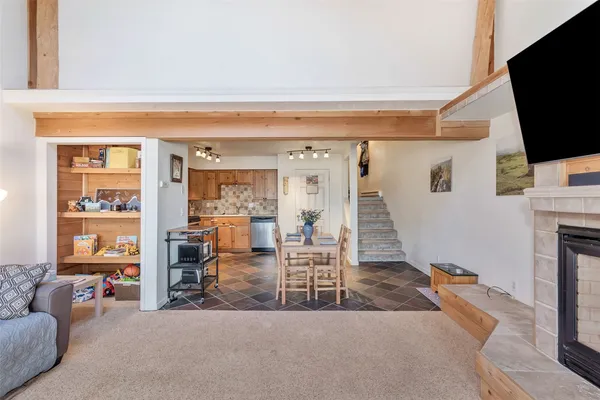 a living room with furniture a flat screen tv and a fireplace