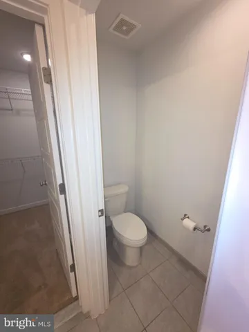 a white toilet sitting next to a shower