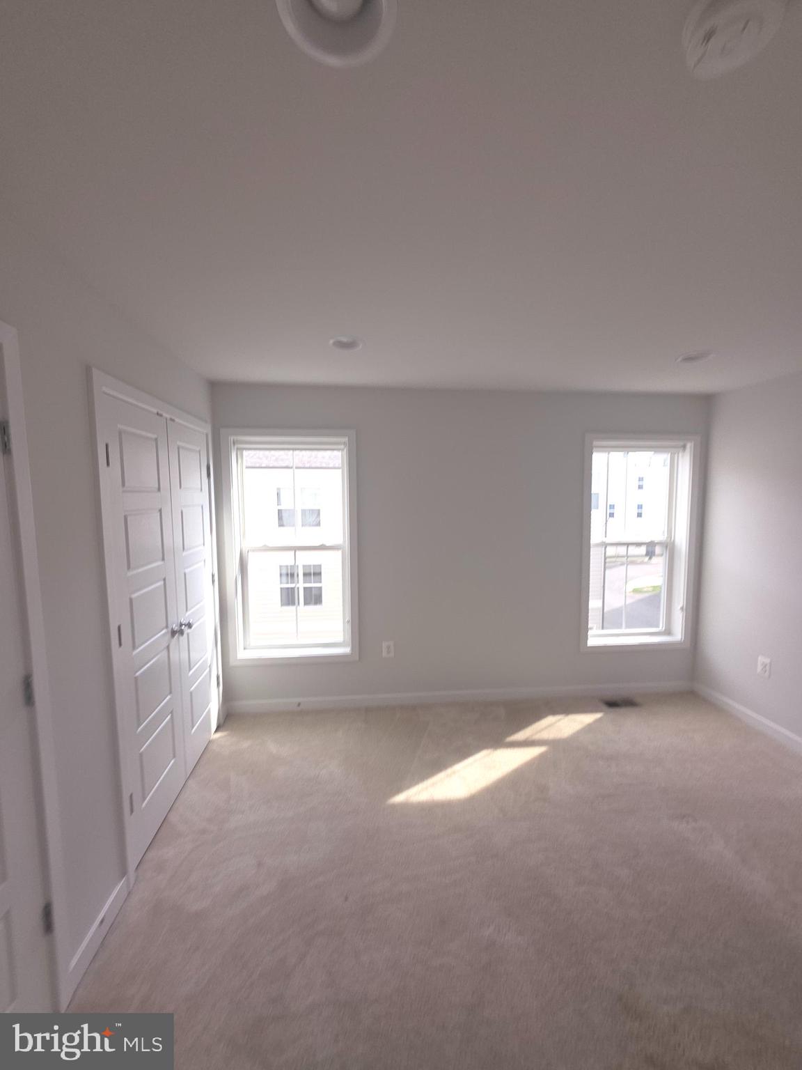 12709 Vuillard Street Silver Spring, MD 20906 - Photo 15 of 28 a view of a big room with windows and chandelier fan