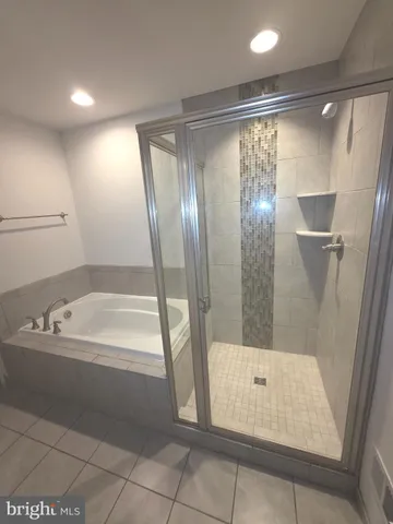 a bathroom with a bathtub and a shower