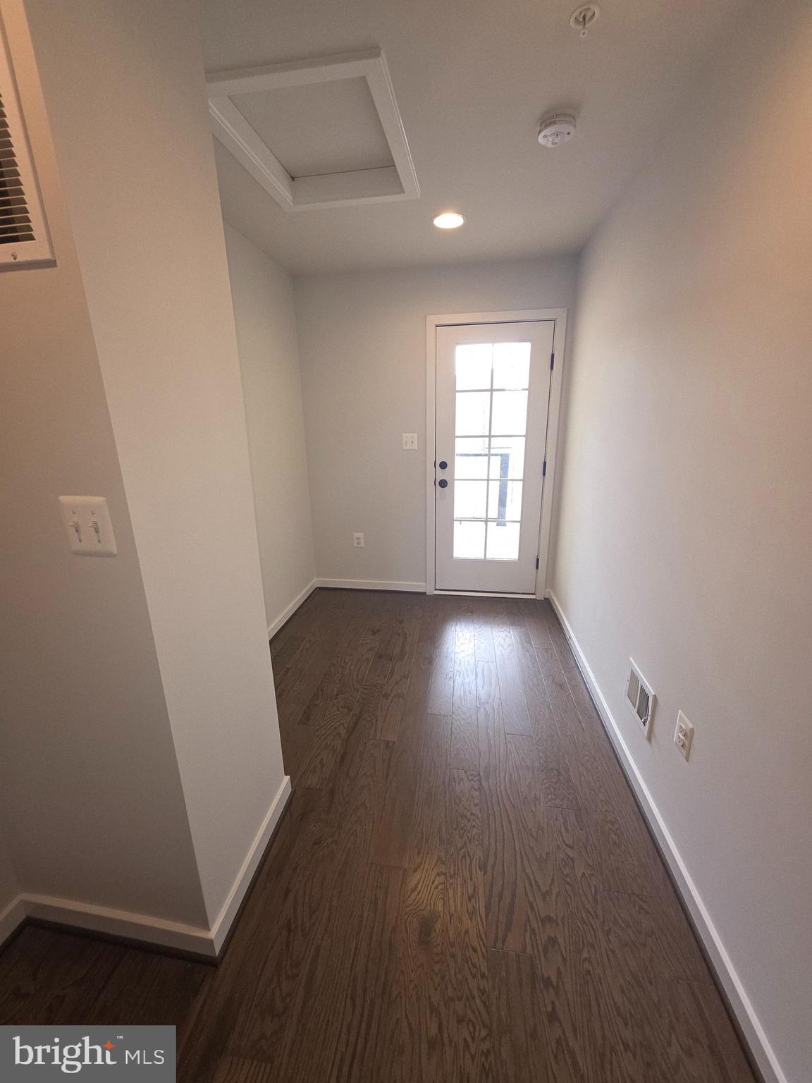 12709 Vuillard Street Silver Spring, MD 20906 - Photo 26 of 28 an empty room with wooden floor and windows