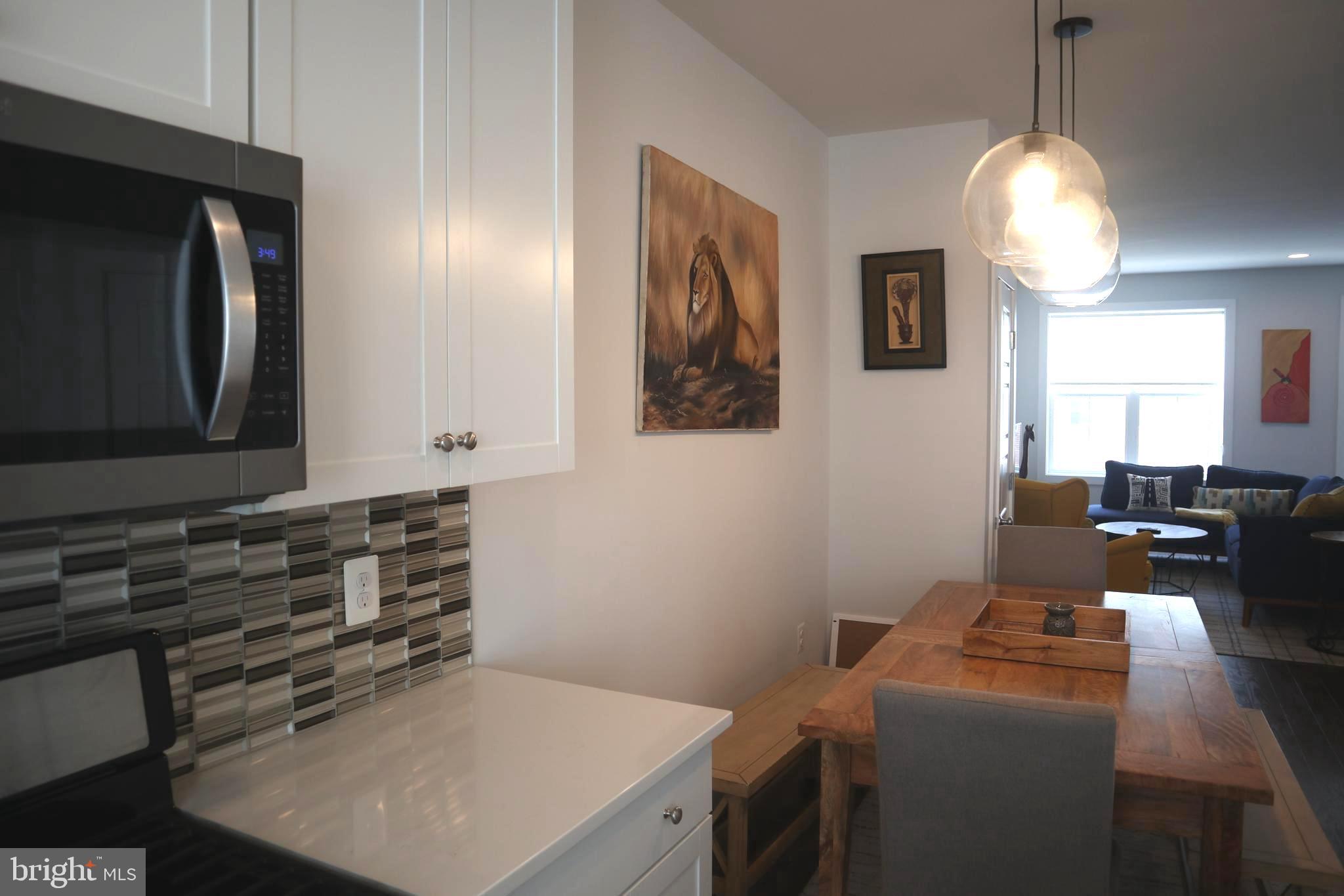 12709 Vuillard Street Silver Spring, MD 20906 - Photo 6 of 28 a kitchen with a stove and a microwave