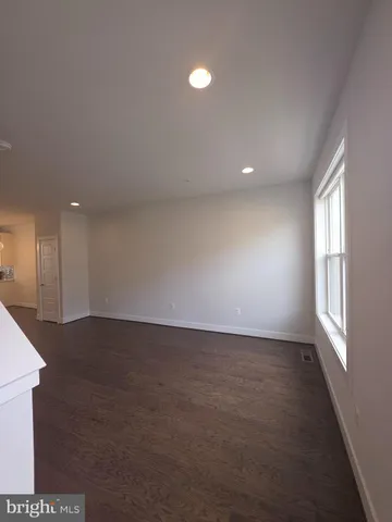 an empty room with windows and entrance