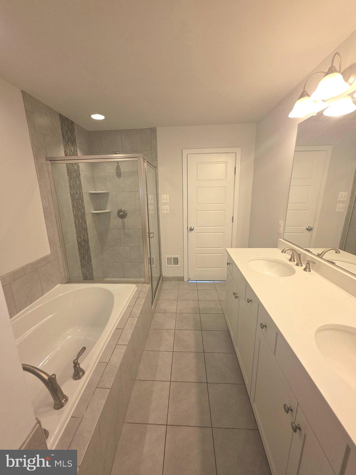 12709 Vuillard Street Silver Spring, MD 20906 - Photo 10 of 28 a spacious bathroom with a tub sink and mirror