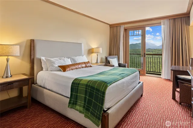 a bedroom with a bed and a large window