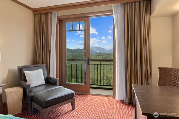 a living room with furniture and a floor to ceiling window