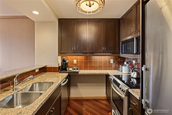 a kitchen with a sink cabinets and stainless steel appliances