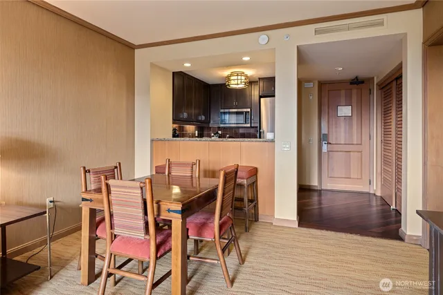 a view of a dining room with furniture and wooden floor