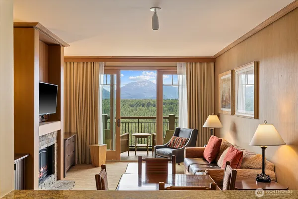 a living room with furniture and a floor to ceiling window