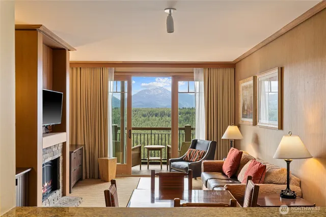 a living room with furniture and a floor to ceiling window