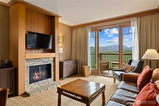 a living room with furniture a flat screen tv and a fireplace