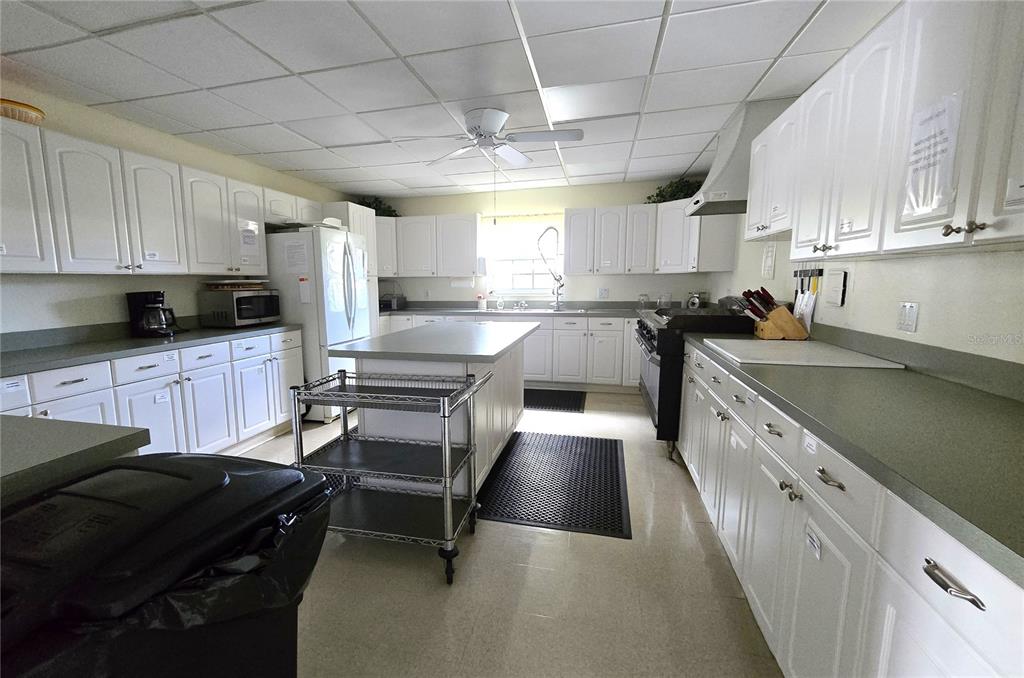 5619 Bayshore Road, Unit 435 Palmetto, FL 34221 - Photo 56 of 56 a kitchen with granite countertop a sink a counter space appliances and cabinets