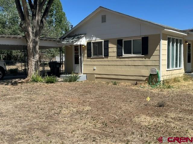 435 South Elm Street Cortez, CO 81321 - Photo 2 of 17 a front view of a house with garden