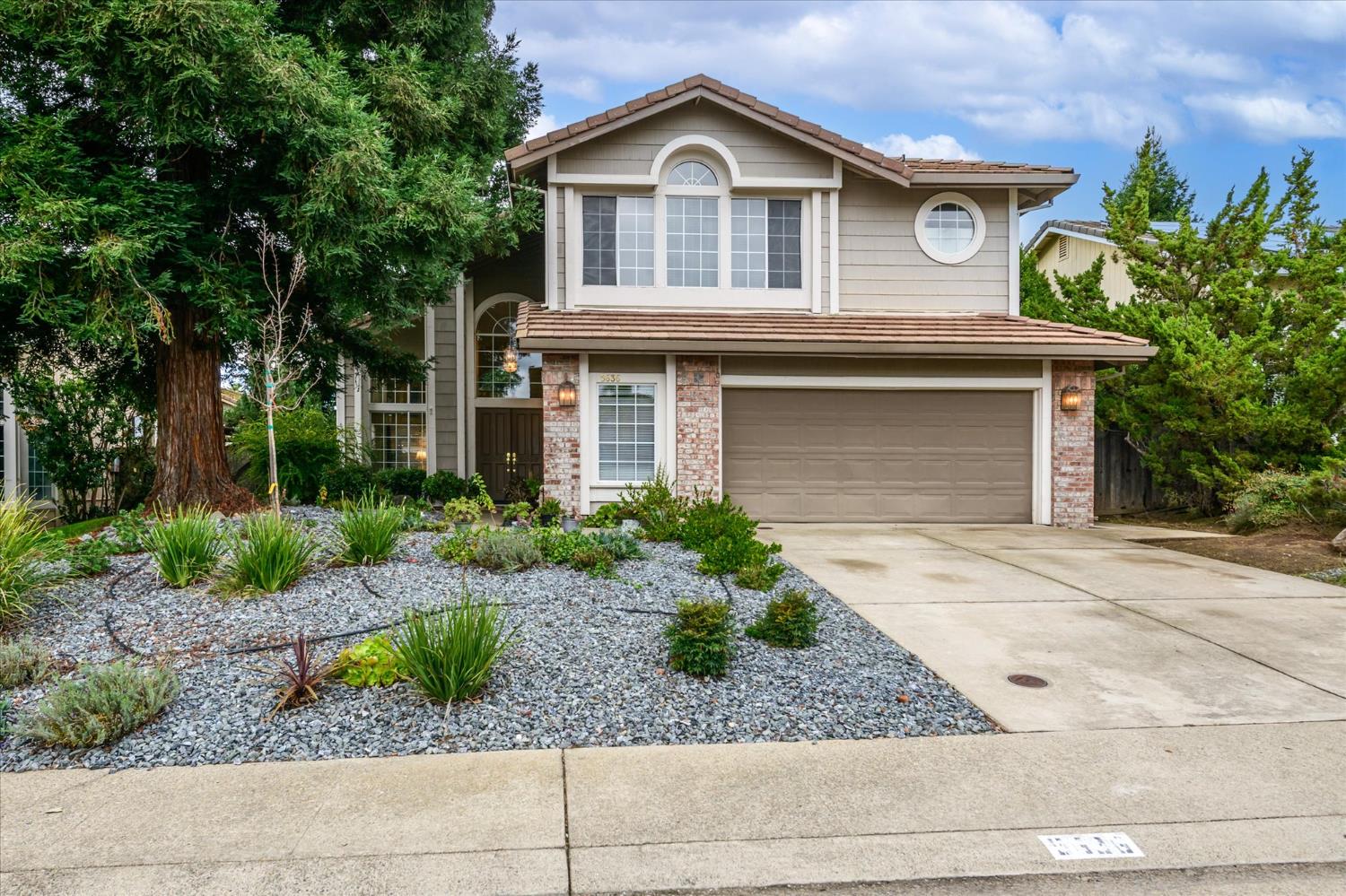 a front view of a house with garden
