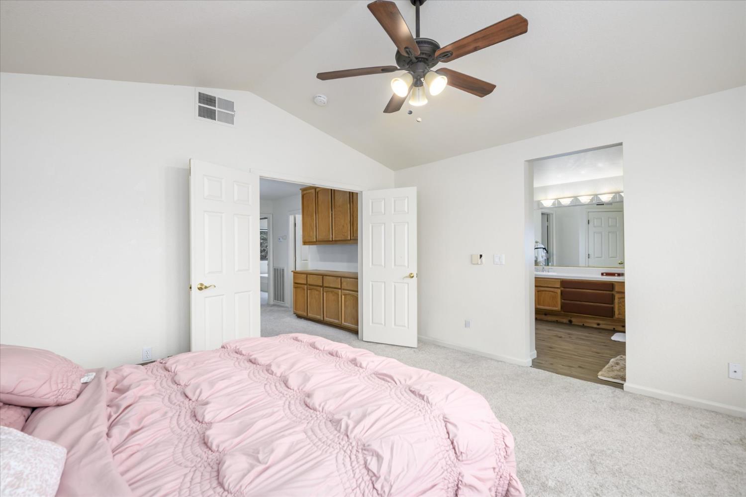 5636 Darby Road Rocklin, CA 95765 - Photo 17 of 29 a bedroom with a bed and a chandelier