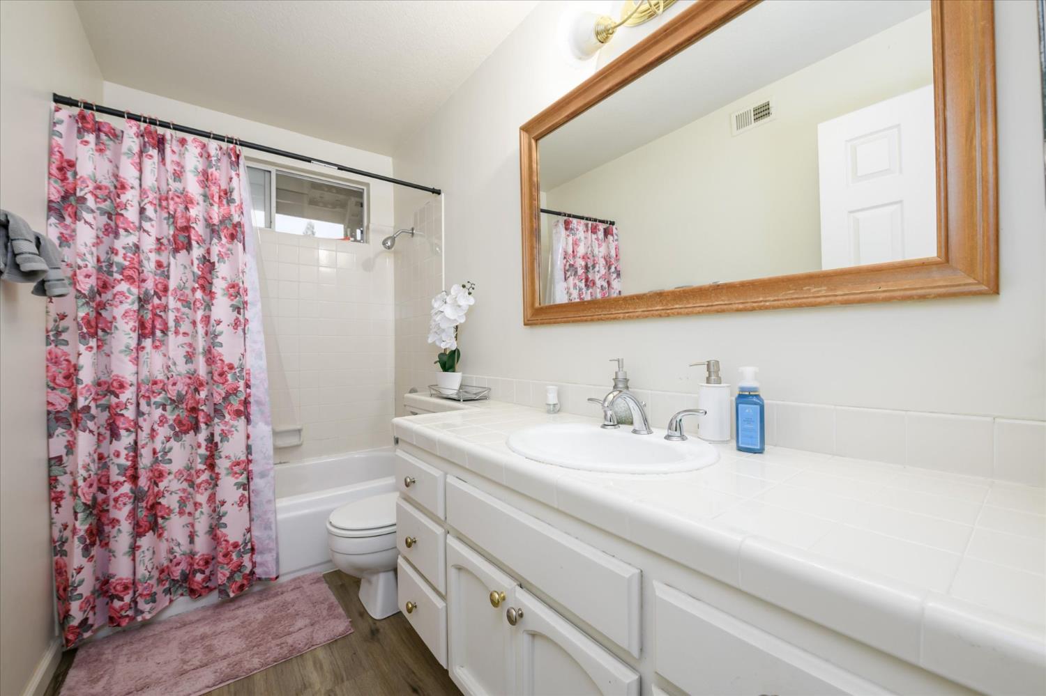 5636 Darby Road Rocklin, CA 95765 - Photo 22 of 29 a bathroom with a sink a toilet and a mirror