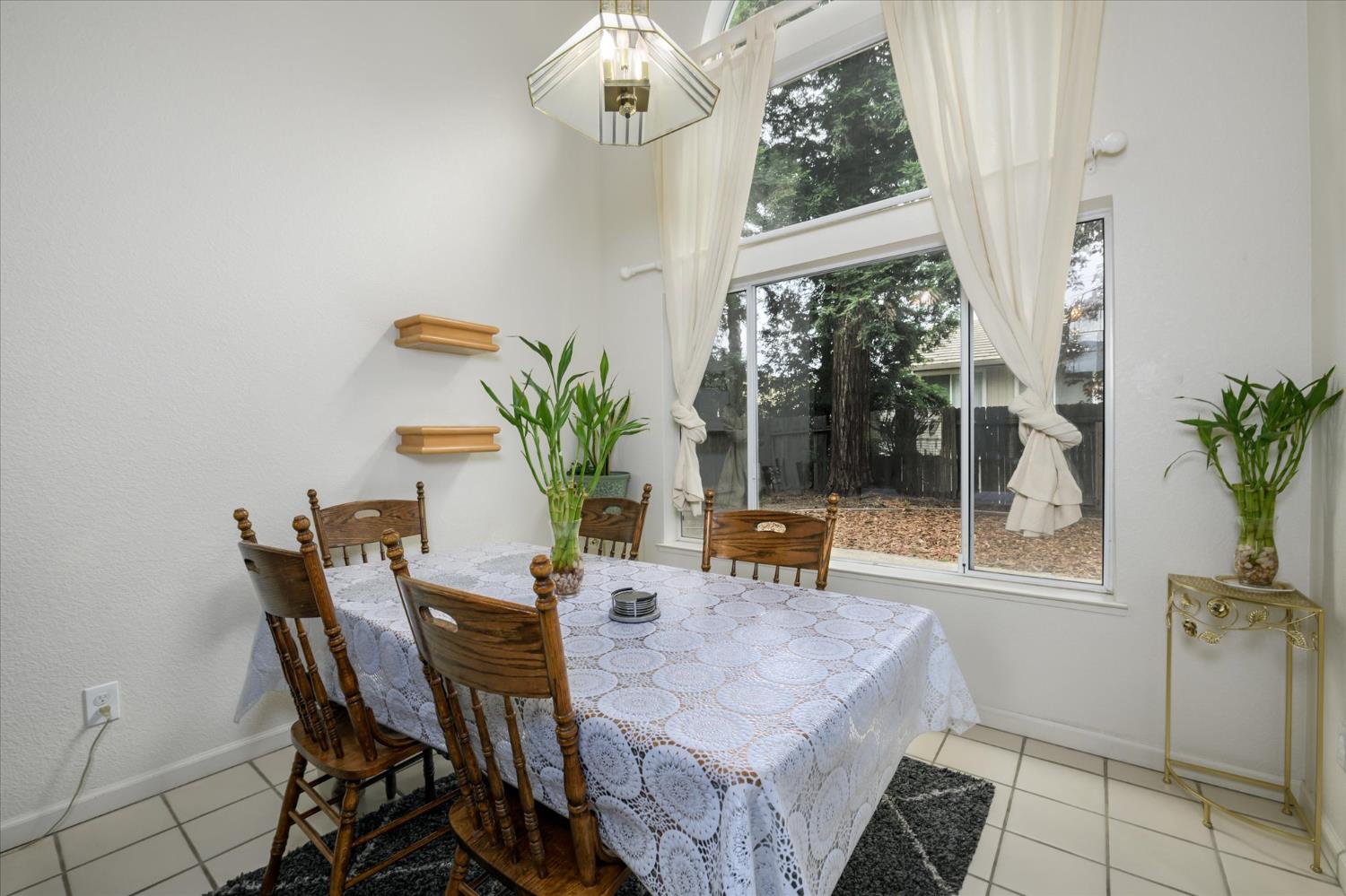 5636 Darby Road Rocklin, CA 95765 - Photo 5 of 29 a dining room with furniture a potted plant and a rug