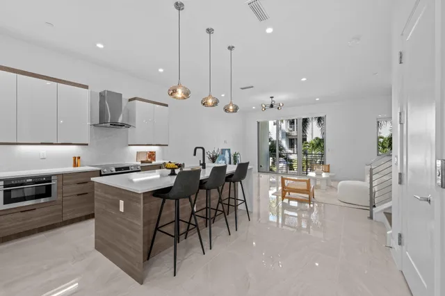 a kitchen with stainless steel appliances granite countertop a stove top oven a sink a counter top space and cabinets