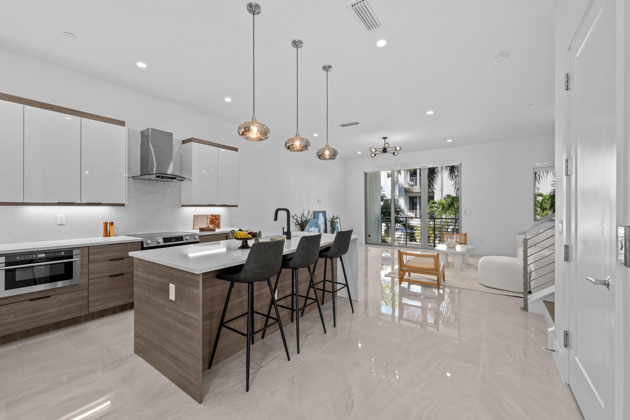 1731 Northwest 40th Drive Boca Raton, FL 33431 - Photo 13 of 26 a kitchen with stainless steel appliances granite countertop a stove top oven a sink a counter top space and cabinets