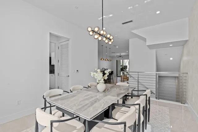 a view of a dining room with furniture and chandelier