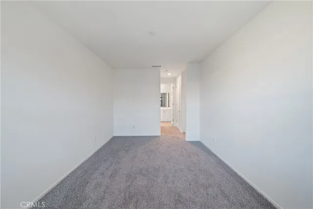 a large kitchen with cabinets wooden floor and stainless steel appliances