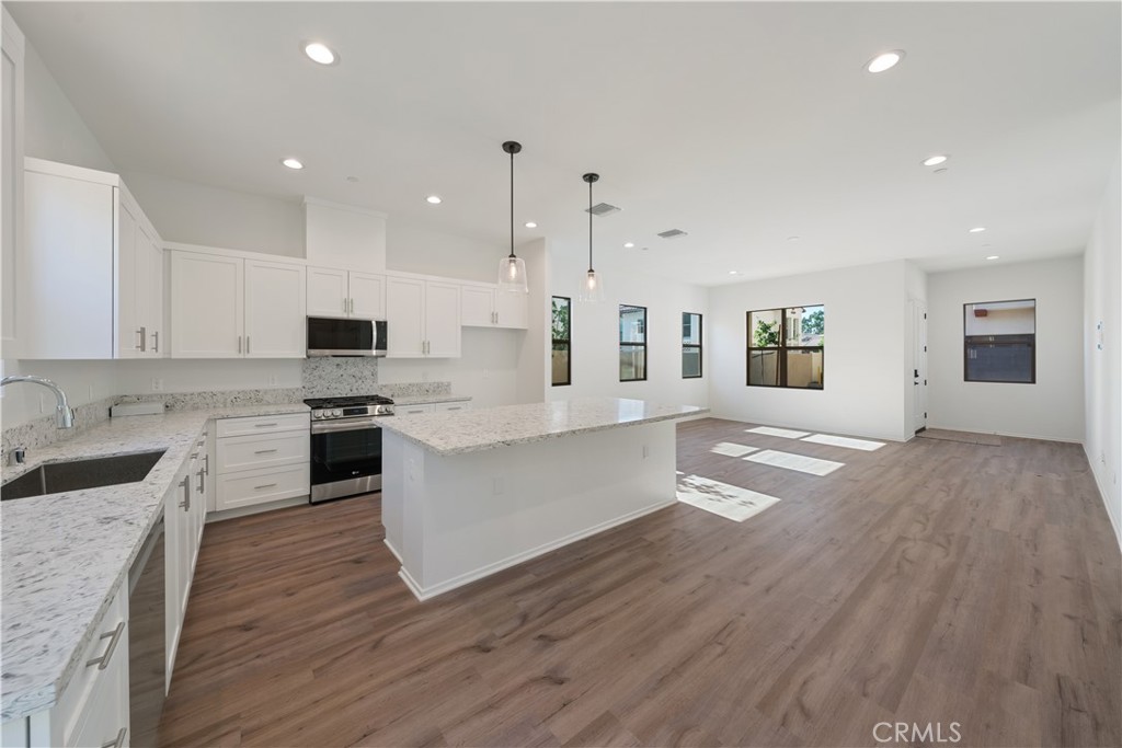 810 Francesca Drive Walnut, CA 91789 - Photo 23 of 33 a large kitchen with cabinets wooden floor and stainless steel appliances