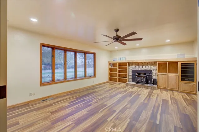 a view of an empty room with a fireplace and a window