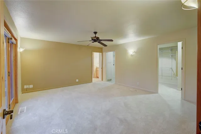 a view of an empty room with a ceiling fan