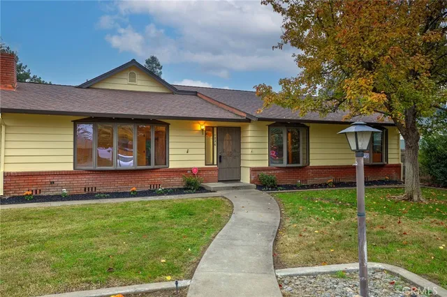 a front view of a house with a yard and porch