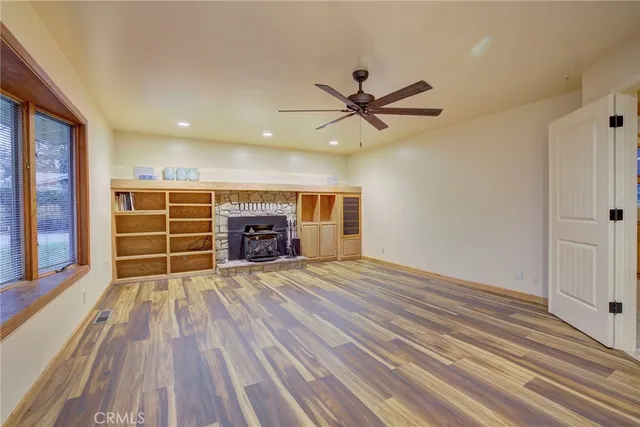 wooden floor in an empty room with a fireplace