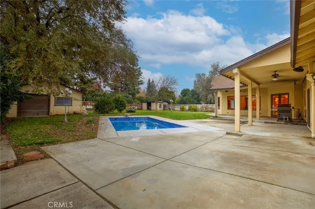 a view of a swimming pool and front of a house