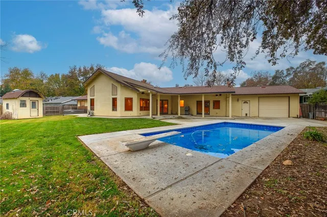 a backyard of a house with table and chairs