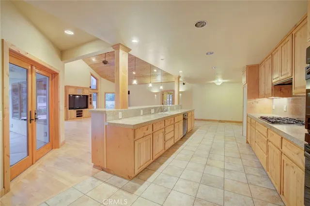 a large kitchen with stainless steel appliances granite countertop a large counter top and a stove