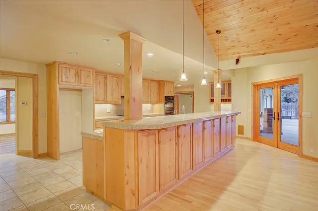 a large kitchen with a large window cabinets and stainless steel appliances