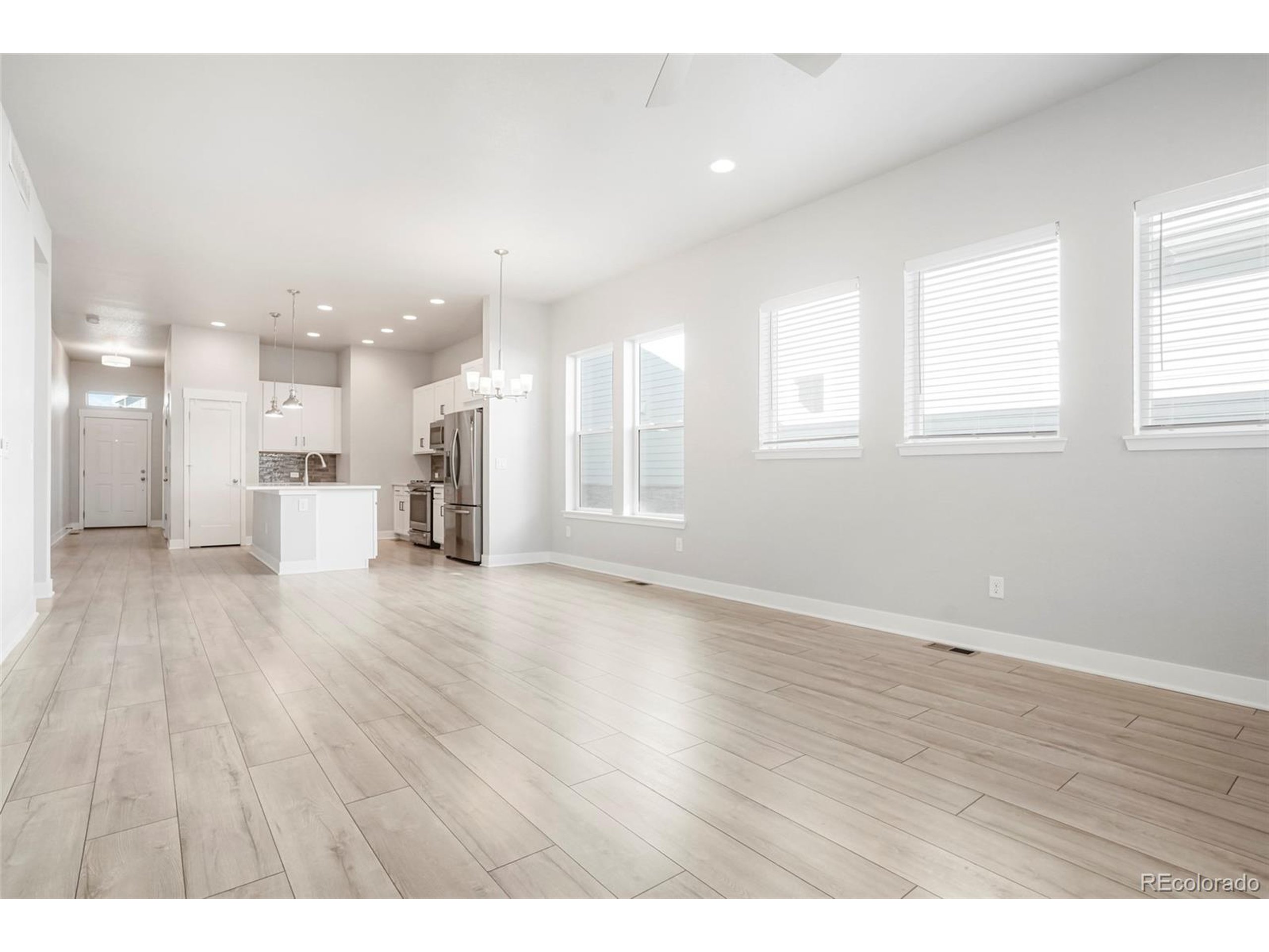 20968 East 60th Place Aurora, CO 80019 - Photo 12 of 50 a view of a kitchen with a counter top space stainless steel appliances and windows