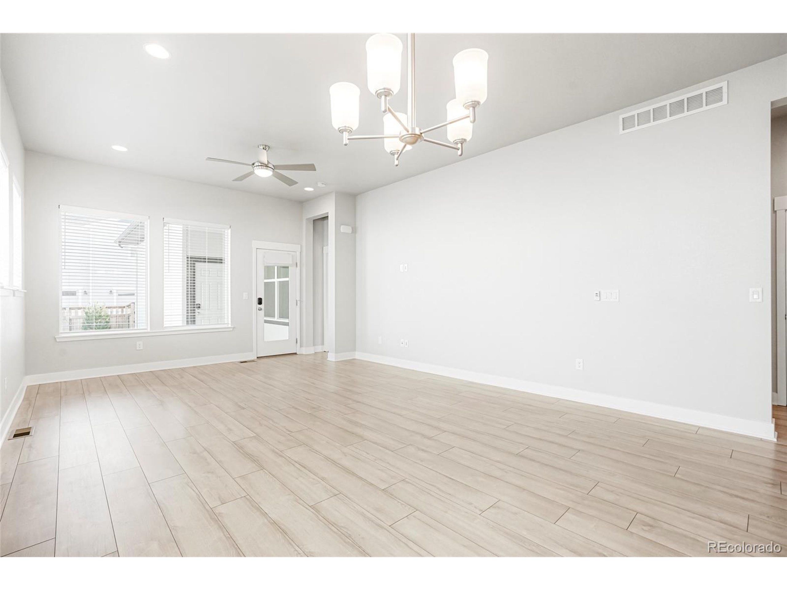20968 East 60th Place Aurora, CO 80019 - Photo 15 of 50 a view of an empty room with wooden floor
