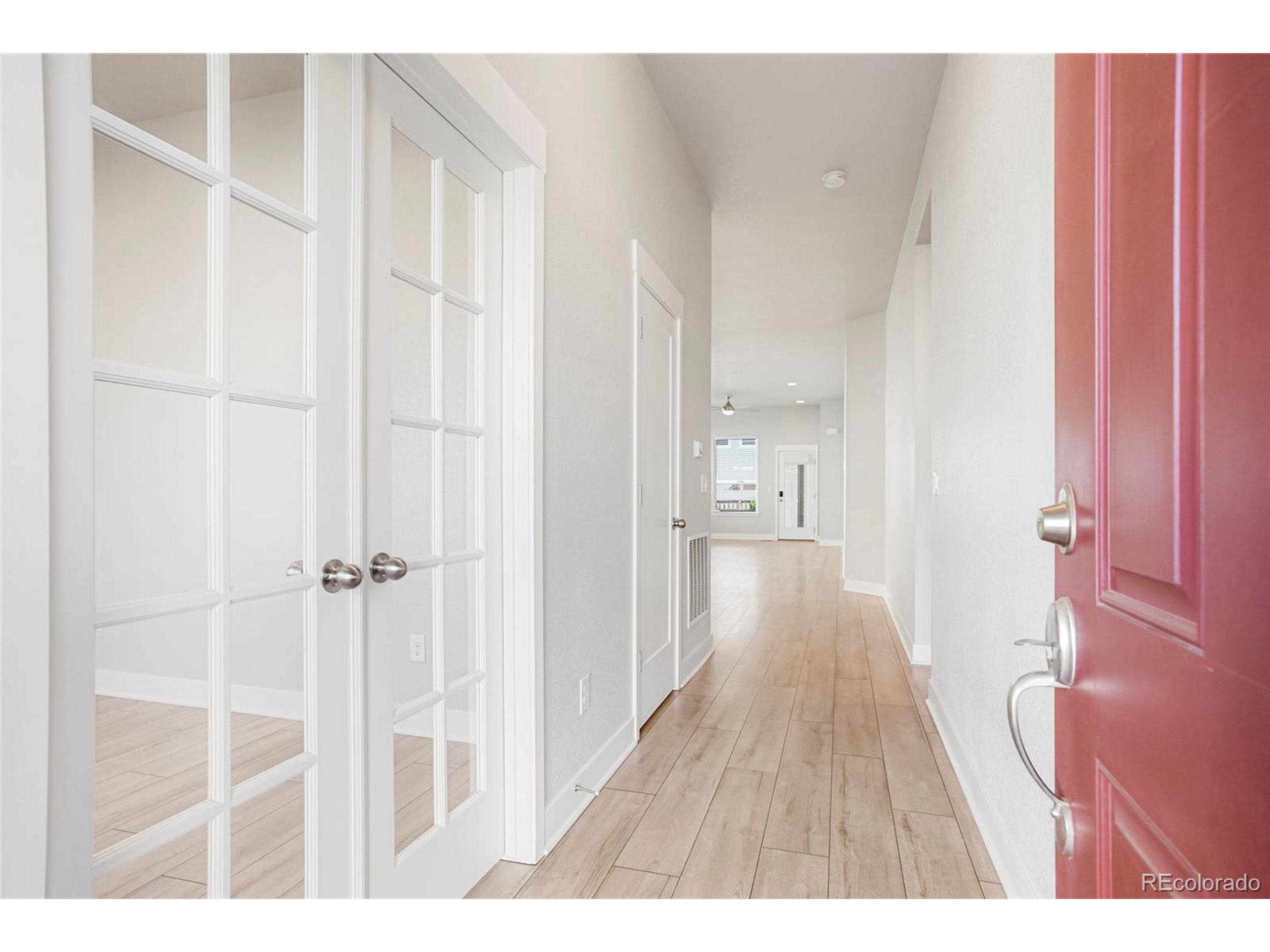 20968 East 60th Place Aurora, CO 80019 - Photo 44 of 50 a view of a hallway with wooden floor and closet