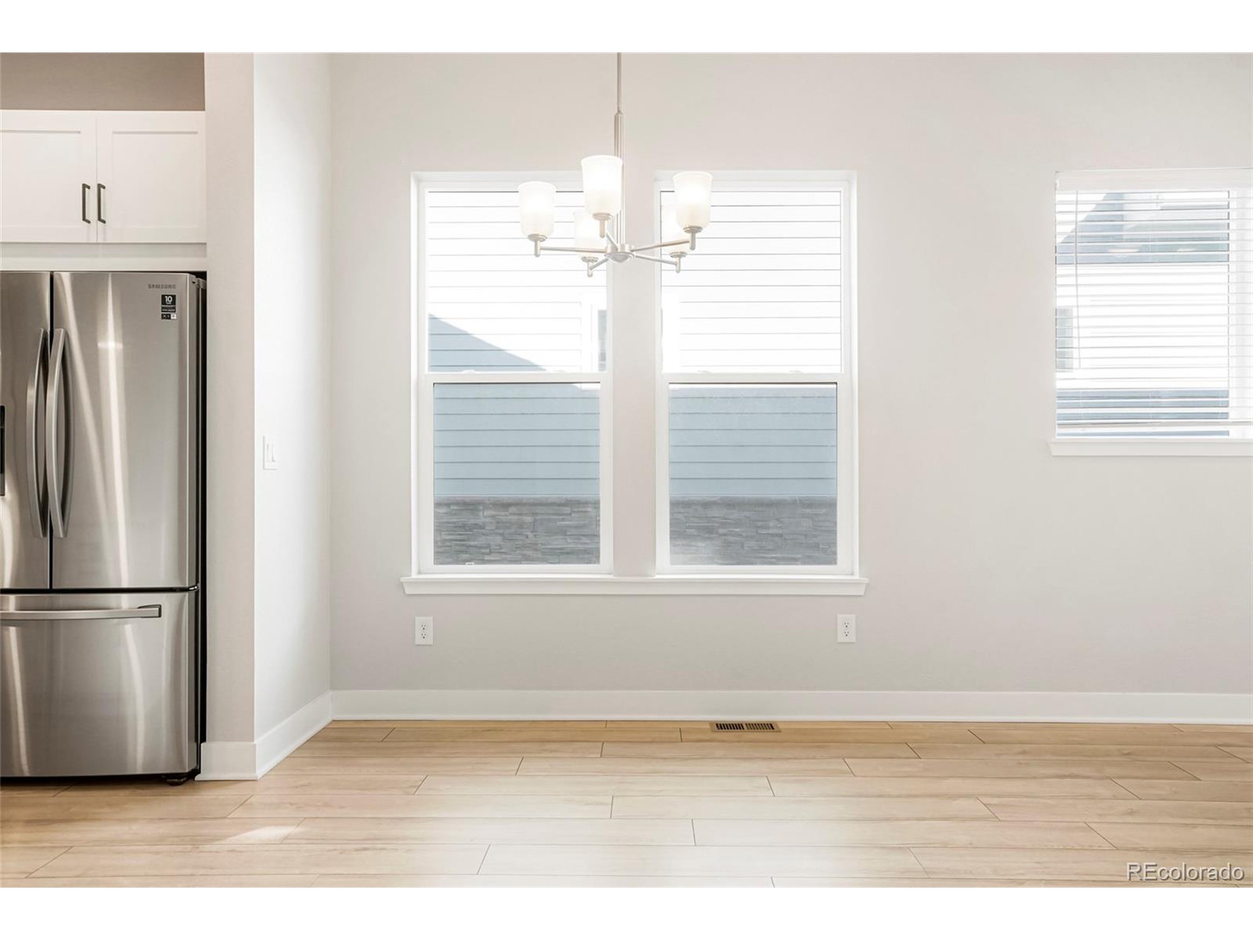 20968 East 60th Place Aurora, CO 80019 - Photo 7 of 50 a view of an empty room with a window