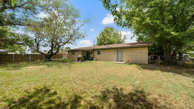 a front view of a house with a yard garage and outdoor seating