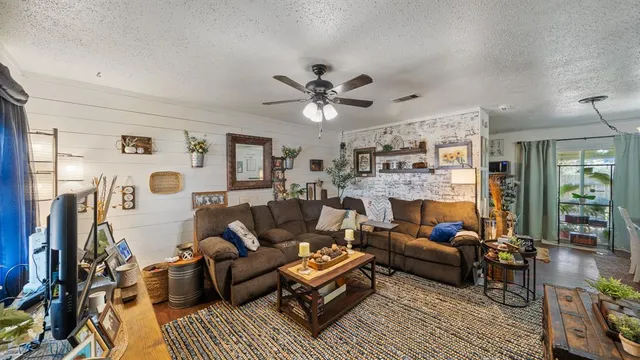 a living room with furniture ceiling fan and a rug
